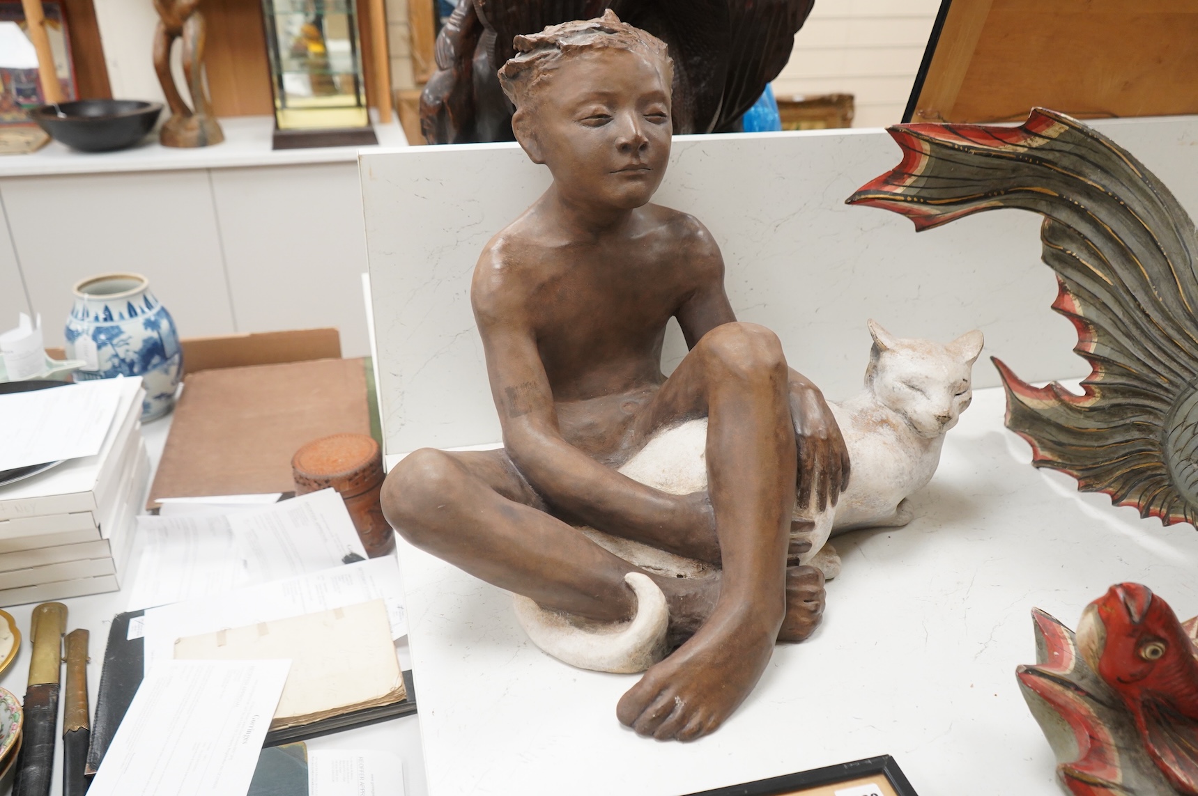 A contemporary composition figure of a seated boy and a cat, 46cm
